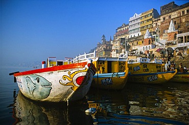 Boats on river Ganges, waiting to take pilgrims for a ride on the holy river, Varanasi, Uttar Pradesh, India, Asia