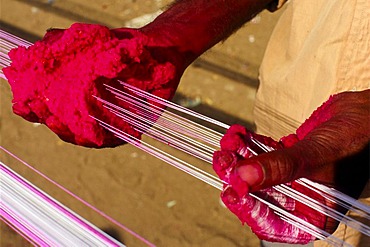 Preparing the kite threads with color and glass powder to cut the other kites off the sky, preparations for the annual kite festival in Ahmedabad, Gujarat, India, Asia