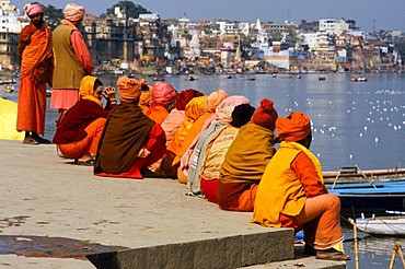 Group of sadhus and sadhvis sitting at the ghats of Varanasi, Uttar Pradesh, India, Asia