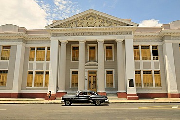 Classic car parked in front of the Colegio San Lorenzo school building, near Parque Marti park, Cienfuegos, Cuba, Caribbean