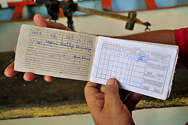 Libreta de Abastecimiento, coupon book for the issue of goods in a bodega, a government store which trades food items for ration coupons, Baracoa, Cuba, Caribbean