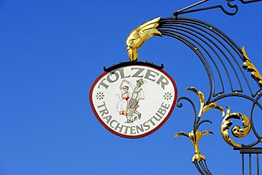 Hanging sign of Toelzer Trachtenstube, an inn on Marktstrasse, the market street of Bad Toelz, Upper Bavaria, Bavaria, Germany, Europe, PublicGround