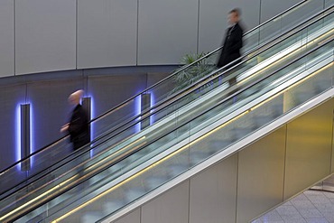 People on an escalator, departure hall at Duesseldorf Airport, North Rhine-Westphalia, Germany, Europe