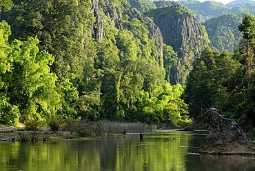 Subtropical river landscape with Lao fishermen fishing with simple nets, Tham Kong Lor, amidst the dense subtropical rainforest, Khammouane, Laos, Southeast Asia, Asia