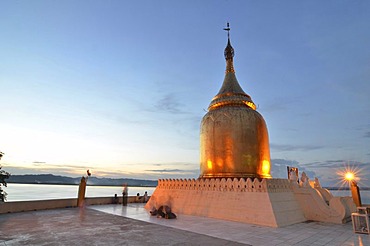 Burmese visitors and pilgrims at the gilded Bupaya Pagoda on the Ayeyarwady river at dusk, Old Bagan, Pagan, Burma, Myanmar, Southeast Asia, Asia