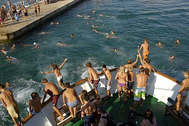 Children jumping from the prow of a ship into the sea, Borik, Zadar, Dalmatia, Adriatic, Croatia, Europe