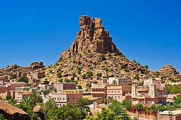 Small village of Aguard Oudad with colourfully painted houses in front of the imposing rocks of Chapeau Napoleon, Napoleon's Hat, Tafraoute, Anti-Atlas Mountains, southern Morocco, Morocco, Africa