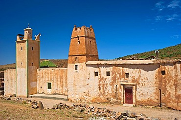 Islamic mosque with a minaret and part of a Kasbah, mud fortress, residential Berber castle, Tighremt, village of Ait Ourhaine, Anti-Atlas Mountains, southern Morocco, Morocco, Africa