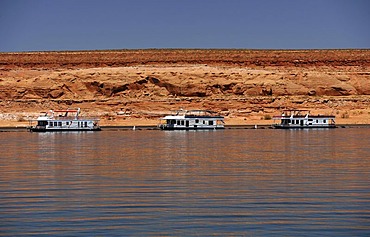 House boats for hire are moored in the harbour of Antelope Point Marina with Tower Butte at back, Lake Powell, Wahweap Marina, Glen Canyon National Recreation Area, Page, Arizona, United States, USA