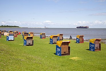 Roofed wicker beach chairs on the grassy beach, Cuxhaven, Lower Saxony, North Sea, Germany, Europe, PublicGround