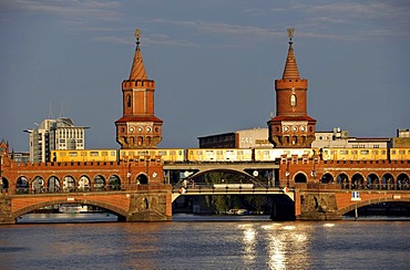 U-Bahn U1 train on Oberbaumbruecke bridge crossing the Spree River in the evening light, Friedrichshain-Kreuzberg, Berlin, Germany, Europe