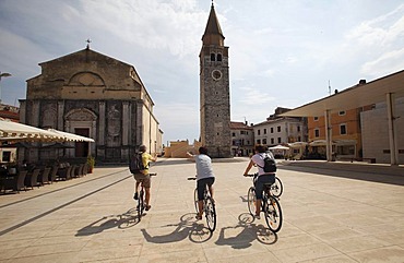 Santa Maria parish church, tourists on bicycles in the Piazza Slobode Liberta, Umag, Istria, Croatia, Europe