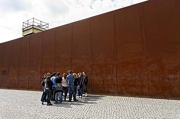 Visitor group standing next to high steel wall, Berlin Wall Memorial, Bernauer Strasse, Mitte quarter, Berlin, Germany, Europe