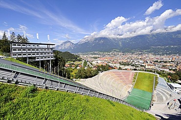 View from Bergisel Schanze ski-jump down onto the stadium, city of Innsbruck and Nordkette or Inntalkette mountain range at the back, Tyrol, Austria, Europe