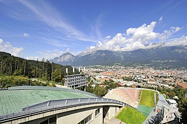 View from Bergisel Schanze ski-jump down onto the stadium, city of Innsbruck and Nordkette or Inntalkette mountain range at the back, Tyrol, Austria, Europe