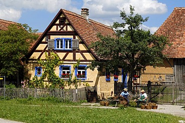 Haeckerhaus building, 1706, left, left, on the right a barn, 1590, both from Ergersheim, in front two basket weavers, Franconian open-air museum, Eisweiherweg 1, Bad Windsheim, Middle Franconia, Bavaria, Germany, Europe