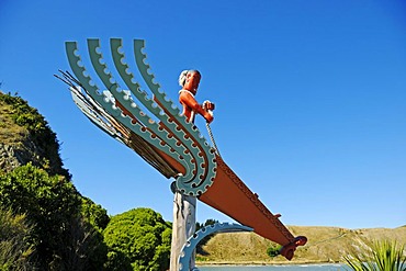 Carved wooden sculpture made by Maori, the native inhabitants, man in a boat, Kaikoura, South Island, New Zealand