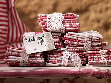 Patchwork fabrics on a craft market at a garden festival at Schloss Buedingen, Hesse, Germany, Europe