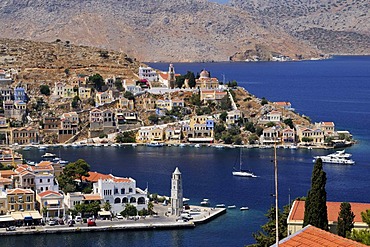 Overlooking the picturesque houses and the clock tower of the small island of Symi near Rhodes, Greece, Europe