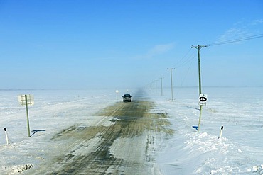 Snow drifts on a northbound road, Saskatchewan, Canada