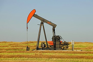 Oil pump producing oil in the prairie, Saskatchewan, Canada