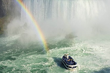 Excursion boat with rainbow directly at the Niagara Falls, Niagara Falls, Ontario, Canada, North America