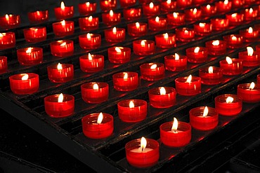 Burning votive candles in a church, St. Martin's Church, Landshut, Lower Bavaria, Bavaria, Germany, Europe