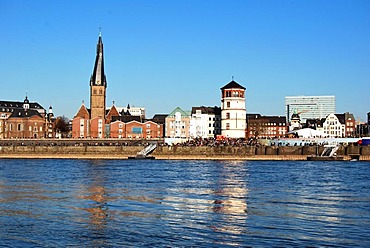 View across the Rhine River to the Basilica of St. Lambertus and Schlossturm tower, headquarters of the Schifffahrtsmuseum or Maritime Museum on the bank of the River Rhine, Burgplatz, old town, Duesseldorf, North Rhine-Westphalia, Germany, Europe