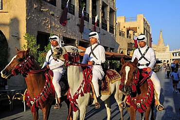 Mounted police in front of the tower of the Islamic Cultural Centre FANAR, Souk Waqif, Doha, Qatar, Middle East