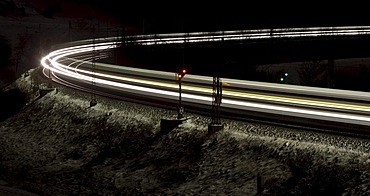 Train as a light trace in winter at night, Lonsee, Baden-Wuerttemberg, Germany, Europe