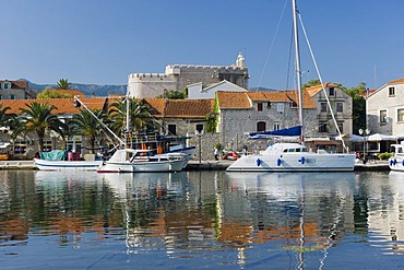 Boats moored off the Fortress Church, Vrboskar, island of Hvar, Dalmatia, Croatia, Europe