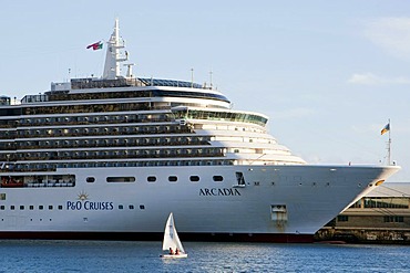 Small sail boat off the cruise ship Arcadia in the marina, Funchal, Madeira, Portugal, Europe