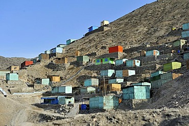 Brightly painted wooden houses built on sandy slopes in the dry desert climate, slums of Amauta, Lima, Peru, South America