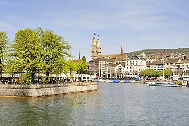 View across the Limmat River towards the beer garden on Bauschaenzli square, Altstadt promenade and the two steeples of Grossmuenster church at the back, Canton of Zurich, Switzerland, Europe