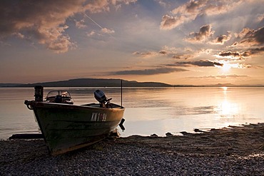 Sunset on Reichenau island with fishing boat and cloud reflection, Baden-Wuerttemberg, Germany, Europe