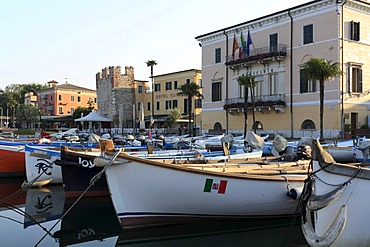 Port of Bardolino with the ruined tower of the Scaliger castle, the Hotel Catullo and the city council, Bardolino, Lake Garda, Veneto, Italy, Europe