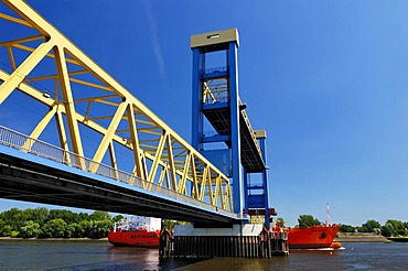 A cargo ship passes under the Kattwykbruecke bridge at Hamburg, Germany, Europe