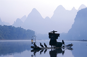 Cormorant fisherman at dawn on the Li River, Guilin, Yangshou, Guangxi Province, China, Asia