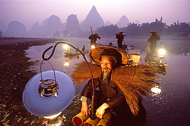 Cormorant fishermen on bamboo rafts on the Li River, Guilin, Yangshou, Guangxi Province, China, Asia