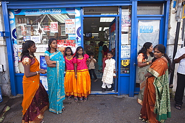 Customers outside Convenience Store, Stratford, London, England, United Kingdom, Europe