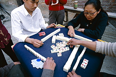 People playing Mahjong, a gambling game, in the street, Beijing, China, Asia