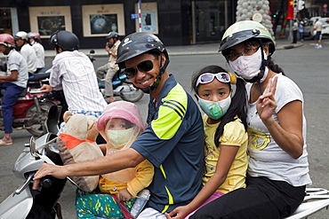 Motorbike passengers wearing pollution mask, Ho Chi Minh City, Vietnam, Indochina, Southeast Asia, Asia 