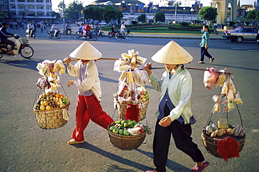 Women vendors carrying produce to market, Ho Chi Minh City (Saigon), Vietna, Indochina, Southeast Asia, Asia