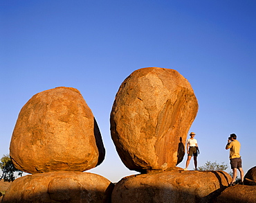 Couple taking photos at the Devils Marbles, Northern Territory, Australia, Pacific