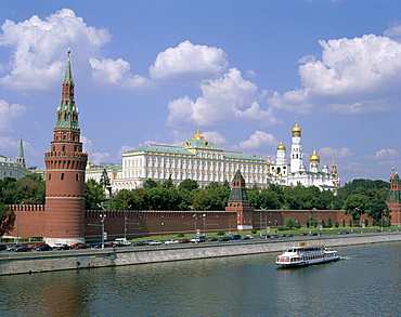 The Kremlin, UNESCO World Heritage Site, and Moskva River with tourist boat, Moscow, Russia, Europe