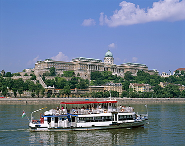 The Royal Palace, Buda, and the River Danube with tour boat, Budapest, Hungary, Europe