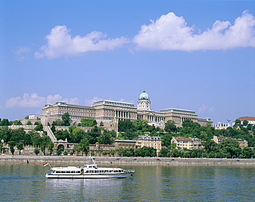 The Royal Palace, Buda, and the River Danube with tour boat, Budapest, Hungary, Europe