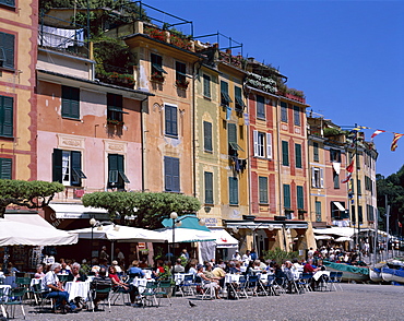 Pastel coloured houses and pavement cafes, Portofino, Liguria, Italy, Europe