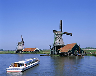 Windmill and canal tour boat, Zaanse Schans, Holland (Netherlands), Europe