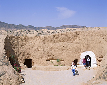 Tourists exiting underground Troglodyte dwellings, Matmata, Tunisia, North Africa, Africa